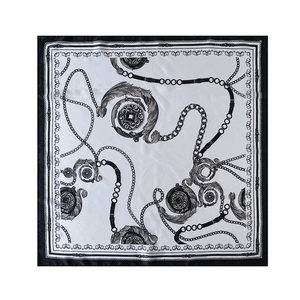 Detail of elegant black and white square scarf with baroque chain and belt prints