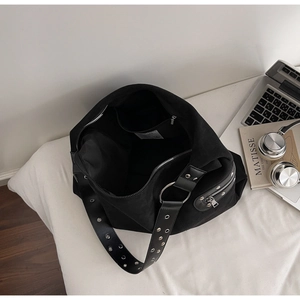 Detail view of large black leopard print tote bag interior with zipper pocket on white bed