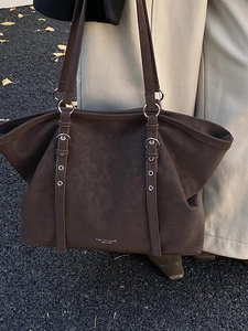 Deep brown matte leather tote bag with metallic ring details for daily commuting wear