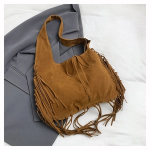 Close-up of bohemian brown suede tote bag featuring long fringes and textured finish