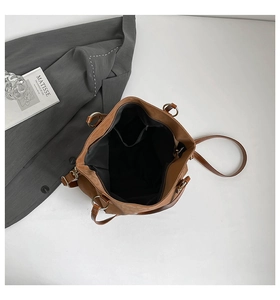 Internal view of brown faux leather tote bag with black lining and inner pockets