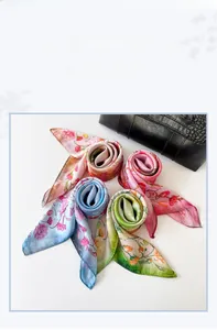 Macro detail of four floral silk square scarves in pink, blue, green and earth tones