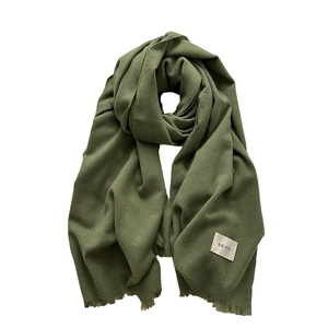 Deep green autumn winter warm scarf with tassel edges and soft twill knit texture