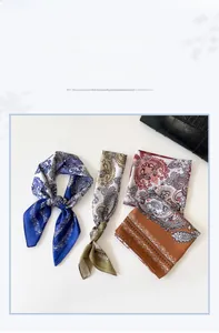 Macro shot of silk-like paisley square scarf showing texture and elegant printing