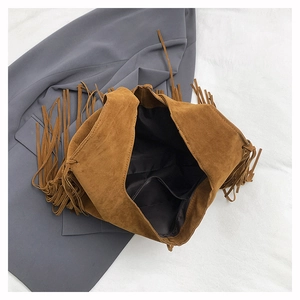 Detailed view of the brown suede fringe tote bag featuring black lining and inner pocket