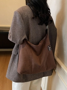Brown suede hobo shoulder bag for women with silver zipper details in retro style