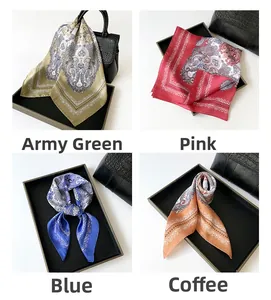 Four color variants of paisley silk-like square scarves displayed on a leather handbag