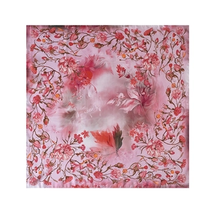 Close-up detail of soft pink floral square scarf featuring intricate carnation print