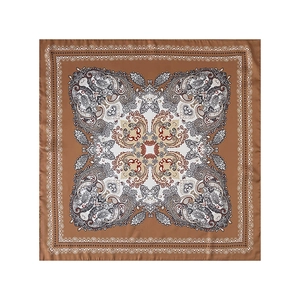 Detailed flat lay of a paisley pattern square silk scarf with brown border and satin finish