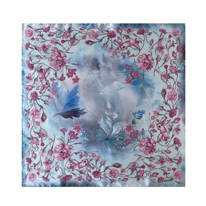Detailed close-up of pink rose print and blue leaves on an elegant silk square scarf
