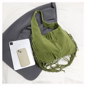Close-up of olive green suede hobo bag featuring tassel fringe and woven braid edge