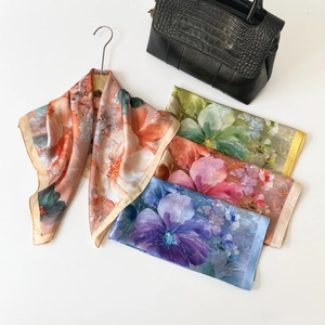 Detailed view of floral silk scarves in vibrant colors with premium stitching quality