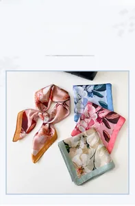 Detail view of four elegant satin square scarves with floral prints in various colors
