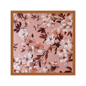 Detail of elegant magnolia flower pattern on a silky satin square scarf for women