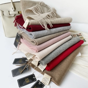 Detail of 100% Australian wool scarves showing soft fringe and luxury fabric texture