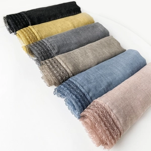 Detailed view of lightweight cotton scarves in six colors featuring elegant lace trim edges