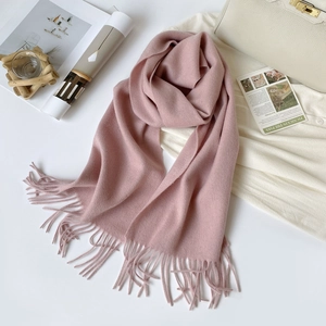 Detail of soft pink Australian wool scarf with fringe on a minimalist lifestyle backdrop
