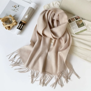 Close-up of beige Australian wool scarf featuring soft fringe and elegant texture