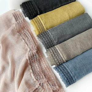 Detailed view of various color options for women's lace trim linen-cotton blend scarves