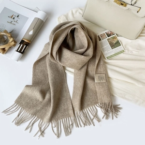 Detail of 100% Australian wool scarf with tassel fringe and wash care label showing material