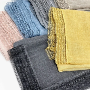 Detail of lace edges and soft cotton-linen fabric texture in various pastel colors
