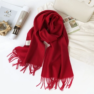 Detail of red 100% Australian wool scarf with tassels and authentic care label
