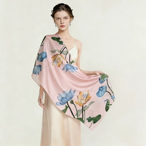 Detail of pink silk shawl with elegant lotus floral prints and smooth satin texture