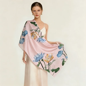 Detail of silk satin shawl with elegant lotus pattern on light pink background