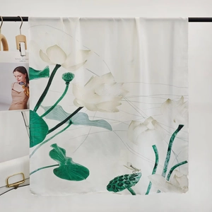 Detailed view of silk scarf with elegant lotus print and smooth hanging texture