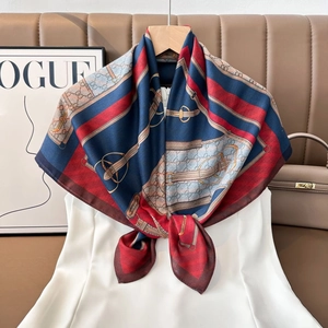 Detail of luxury silk scarf with vintage equestrian print and horsebit pattern tied on dress