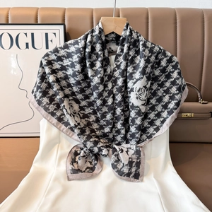 Close-up of double-sided velvet scarf with houndstooth and floral print on hanger
