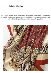 Close-up of red and gold paisley satin silk scarf showing soft fabric texture and drape