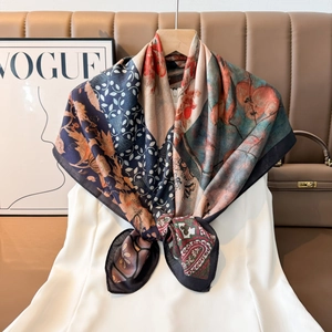 Detailed view of luxury square scarf with vintage floral and paisley print styling