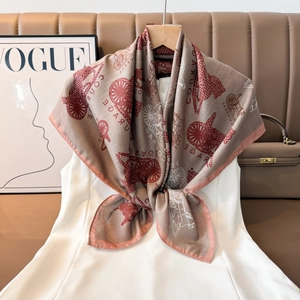 Close-up of vintage silk scarf featuring carriage prints and classic paisley patterns