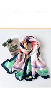 Close-up of a digital printed silk shawl with colorful abstract art patterns and sunglasses