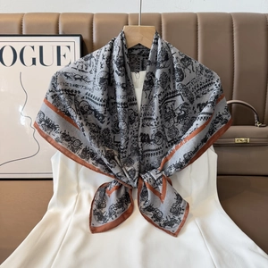 Detail of vintage carriage print silk scarf styled as an elegant shawl over a white dress