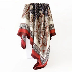 Detail of satin square scarf featuring vintage paisley patterns and geometric borders