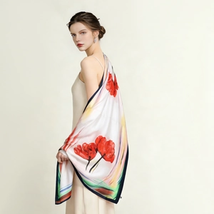 Detail of red floral print silk scarf with navy contrast border for beach cover-up