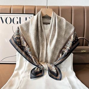 Detail of satin paisley scarf with herringbone texture draped over a white dress