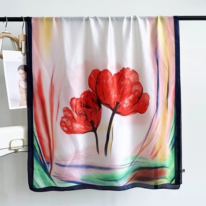 Detail of red floral print on premium white silk scarf with fine dark blue hand-rolled edges