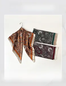 Macro detail of 90cm paisley silk square scarves in brown, green and burgundy tones