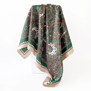 Close-up of 90cm satin silk scarf with detailed vintage paisley floral patterns in dark green