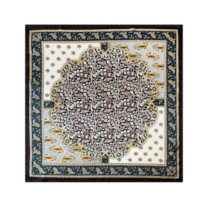 Detailed top view of paisley silk scarf with classic floral patterns and black borders