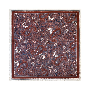Close-up of square silk scarf with paisley pattern in dark red and navy blue colors