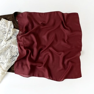 Close-up of lightweight burgundy square scarf with elegant herringbone weave texture