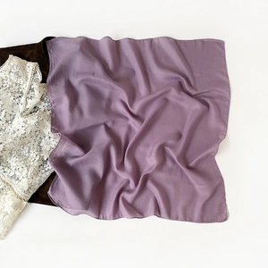 Detailed view of lavender purple cotton-linen hijab with fine herringbone texture and soft folds