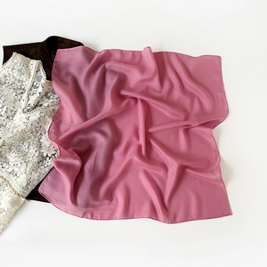 Detailed view of mauve semi-transparent chiffon square scarf with fine rolled hem edges