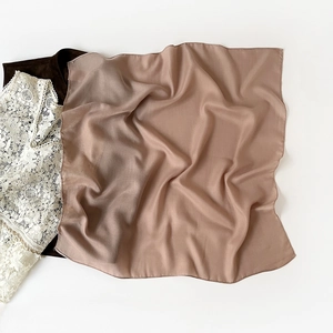 Detail of pink brown square scarf showing lightweight semi-transparent fabric texture