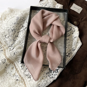 Detailed view of dusty rose scarf featuring a classic herringbone weave pattern