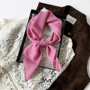 Detail showing rose pink silk scarf with herringbone texture and soft silky luster